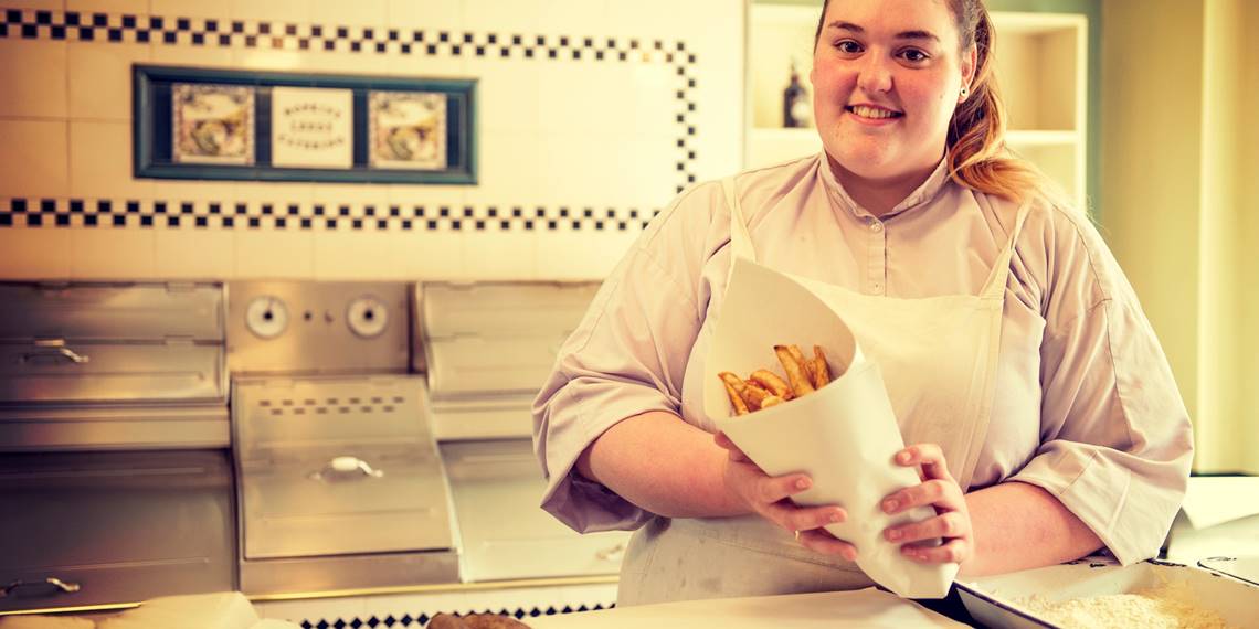 woman at the fried fish dealer at Blists Hill in Ironbridge